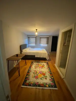 a bedroom with a bed and a rug on the floor at Zelya Istanbul Flats in Istanbul