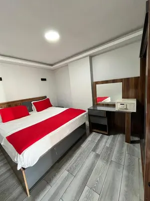 a bedroom with a large bed and a desk at Deniz Hotel Kumburgaz in Buyukcekmece