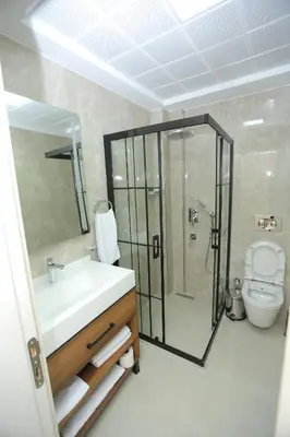 a bathroom with a sink and a shower and a toilet at HaciBayramHotel in Istanbul