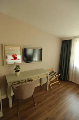 a room with a desk with a television and a chair at HaciBayramHotel in Istanbul
