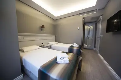 two beds in a hotel room with towels on them at Semsan Hotel in Istanbul