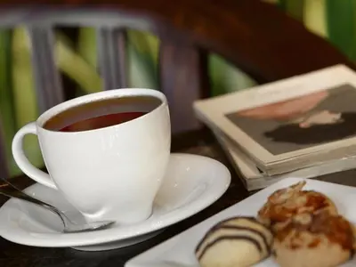 a cup of coffee on a table with a plate of food at Valide Hotel in Istanbul