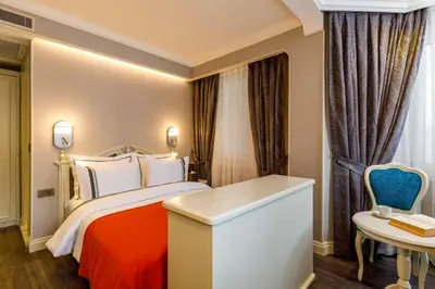 a hotel room with a bed and a desk at Amiral Palace Hotel Boutique Class in Istanbul