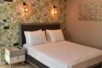 a bedroom with a bed with white sheets and pillows at Noya Köşk Otel in Adalar
