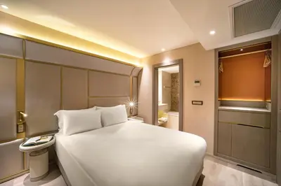 a bedroom with a large white bed and a bathroom at Bentley Hotel Bosphorus - Special Class in Istanbul