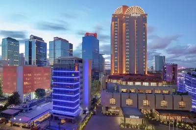 a city skyline with tall buildings in a city at Hilton Istanbul Maslak in Istanbul