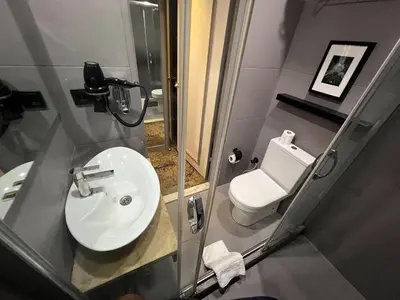 a bathroom with a white sink and a toilet at All Seasons Hotel in Istanbul