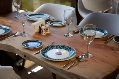 a wooden table with blue and white plates and wine glasses at Casa Giallo Managed By Dedeman in Sapanca