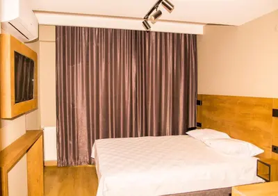 a hotel room with a bed and a window at Fidanoğlu Suite Hotel Çorlu in Corlu