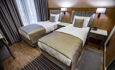 a hotel room with two beds and a window at Hamitbey Hotel Yenikapı in Istanbul