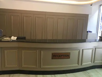 a reception desk with a sign that reads reception at Laleli Gonen Hotel in Istanbul