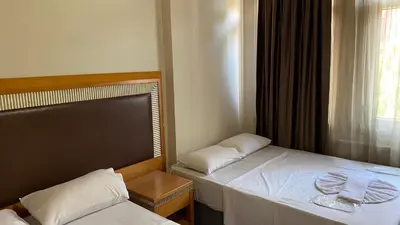 a bedroom with two beds and a window at Herton Boutique Hotel in Istanbul