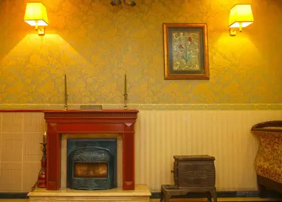 a room with a fireplace with two lights on the wall at Hotel Erguvan - Special Category in Istanbul