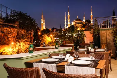 a restaurant with tables and chairs with a view of the blue mosque at Hotel Erguvan - Special Category in Istanbul