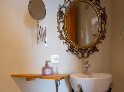 a bathroom with a sink and a mirror on the wall at Fatih Balat tarihin içinde şık bir ev 2 in Istanbul