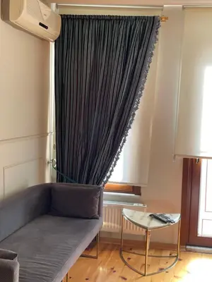 a living room with a couch and a window at Fatih Balat tarihin içinde şık bir ev 2 in Istanbul