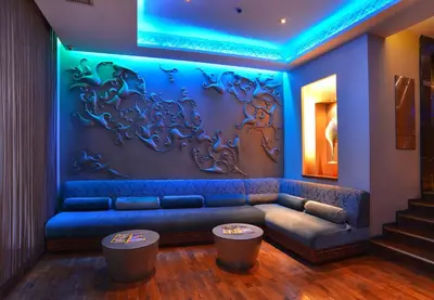 a living room with a blue couch and two stools at Pera Tulip Hotel & Spa in Istanbul