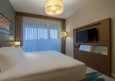 a bedroom with a large bed and a television at The Superior Living Batışehir in Istanbul