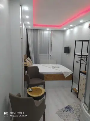 a small room with a bed and a chair at CEMRE SUIT in Istanbul