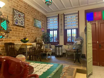a living room with a table and chairs and a brick wall at Çırağan's Omnia Hotel in Istanbul