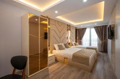 a bedroom with a bed and a glass shower at Luxury Airport Hotel By Zazzoni-İstanbul Airport in Arnavutköy
