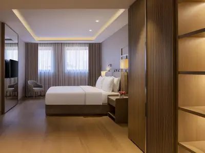a hotel room with a bed and a desk at Mövenpick Hotel Istanbul Bosphorus in Istanbul
