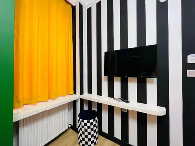 a room with black and white stripes and a tv at Apex Hotel in Istanbul