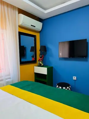 a bedroom with a bed and a blue wall at Apex Hotel in Istanbul