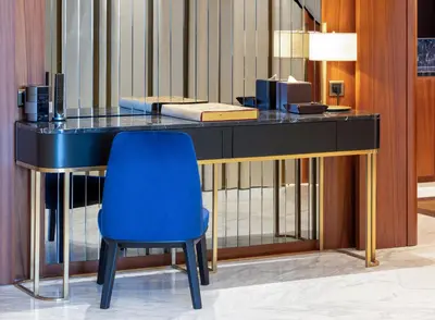 a desk with a blue chair in a room at The Maestro Hotel in Istanbul
