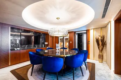 a dining room with a table and blue chairs at The Maestro Hotel in Istanbul