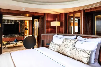 a bedroom with a bed and a desk and a television at The Maestro Hotel in Istanbul