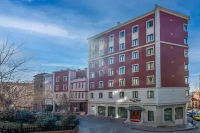 a large red building on a city street at Grand Yavuz Hotel Sultanahmet in Istanbul