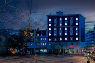 a tall building with many windows at night at Grand Yavuz Hotel Sultanahmet in Istanbul