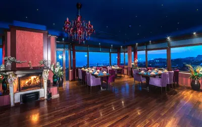 a dining room with tables and a fireplace at Grand Yavuz Hotel Sultanahmet in Istanbul