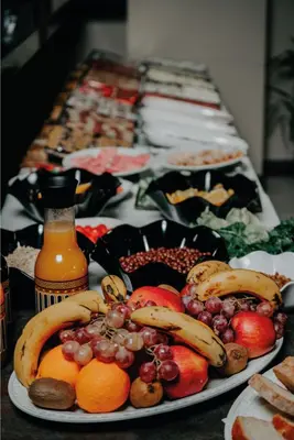a table with a plate of fruit on a table at Grand Quars Hotel in Avcılar