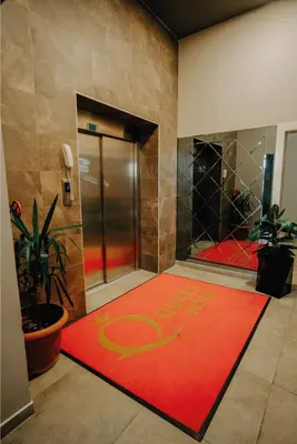 a lobby with a red carpet with the word exit on it at Grand Quars Hotel in Avcılar