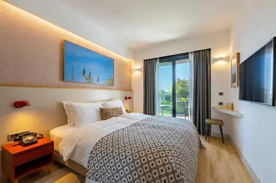 a bedroom with a bed and a large window at Pınar Otel in Erdek