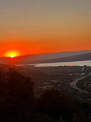 a sunset over a city and a body of water at LakeviewhouseSapanca in Sapanca