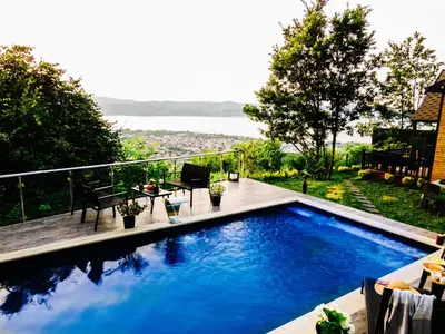 a swimming pool with a view of the water at LakeviewhouseSapanca in Sapanca