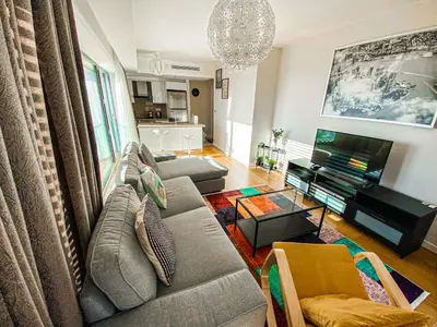 a living room with a couch and a tv at Cebeci Residence Pendik in Istanbul