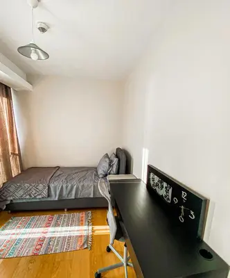 a bedroom with a bed and a desk with a computer at Cebeci Residence Pendik in Istanbul