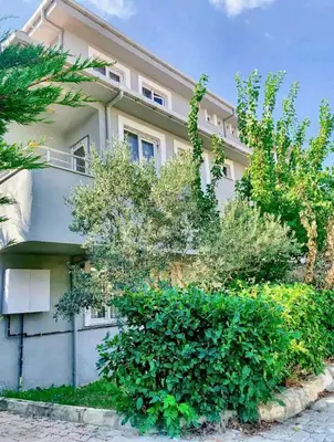 a white building with bushes in front of it at Ahmet Teacher's villa is 6 minutes from Istanbul airport in Arnavutköy