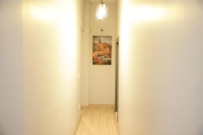 a hallway with a white wall and a painting at Bonita Apart in Istanbul