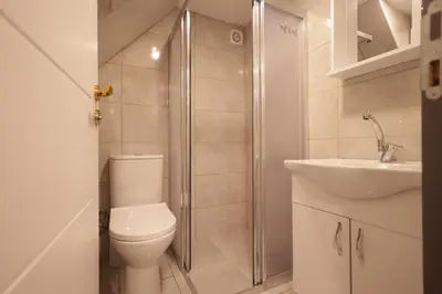 a bathroom with a toilet and a shower and a sink at Bonita Apart in Istanbul