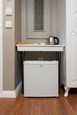 a white table with a white refrigerator under a counter at Azalea Mansion Oldcity in Istanbul