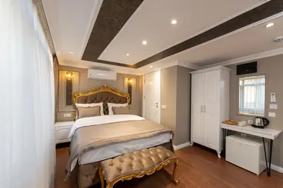 a bedroom with a large bed with a gold headboard at Azalea Mansion Oldcity in Istanbul
