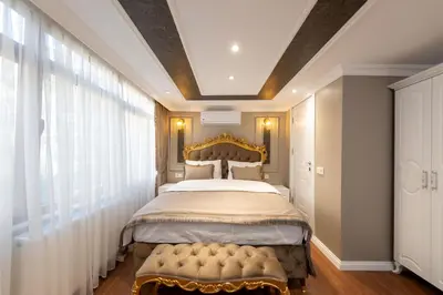 a bedroom with a large bed with a gold headboard at Azalea Mansion Oldcity in Istanbul