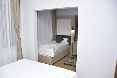 a bedroom with two beds and a mirror at Hotel Arinna in Istanbul