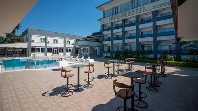 a group of stools and tables in front of a building at Lake Life Hotel in İznik