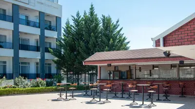 a group of tables and chairs in front of a building at Lake Life Hotel in İznik